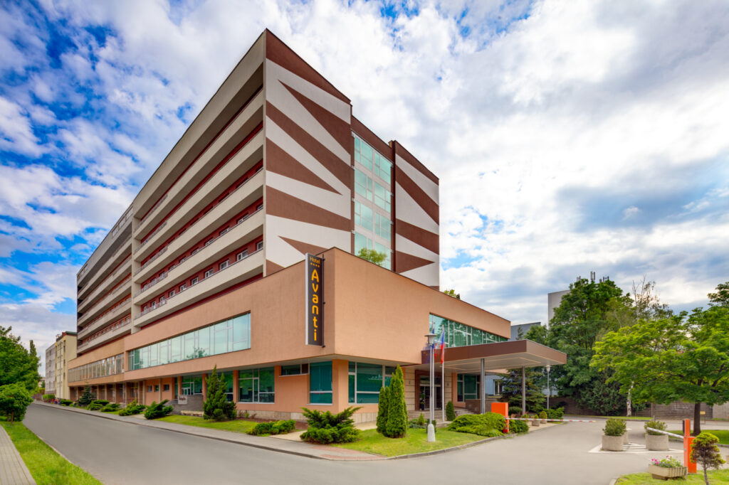 Avanti hotel building under blue sky with clouds