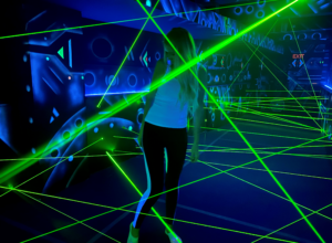 The lady behind the green lasers in the premises of the Laser Labyrinth in Brno