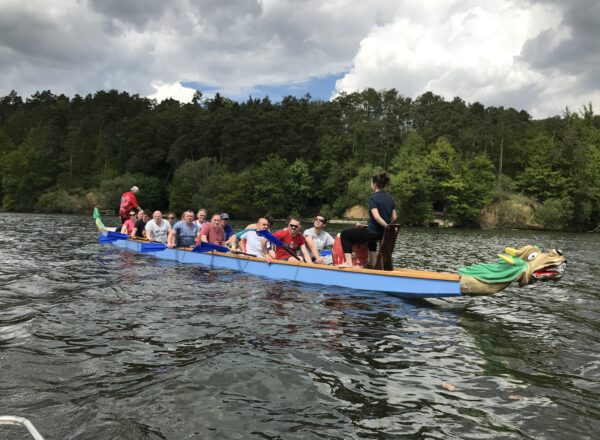 A dragon boat on the Brno dam under big clouds
