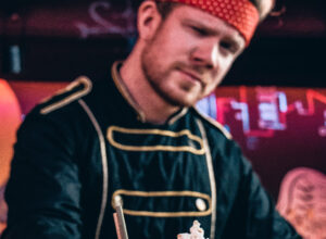 A special glass for drinks served by a bartender from Super Panda Circus