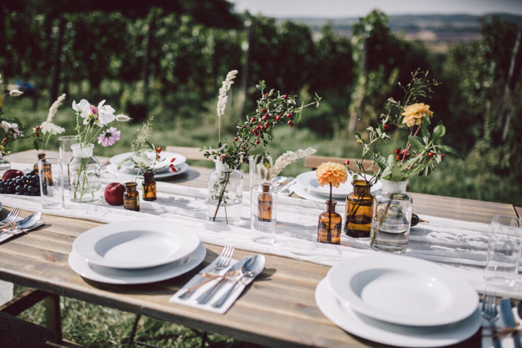 Table set in the vineyard with plates and flowers