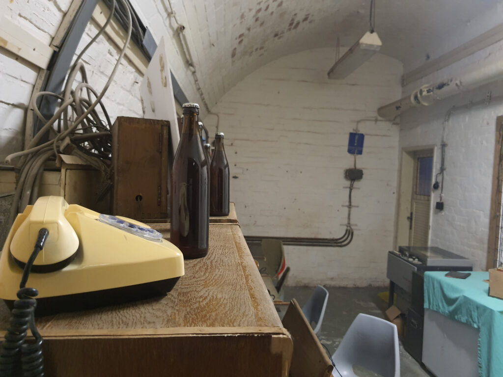 Interior of Bunker 10-z with telephone and glass bottles