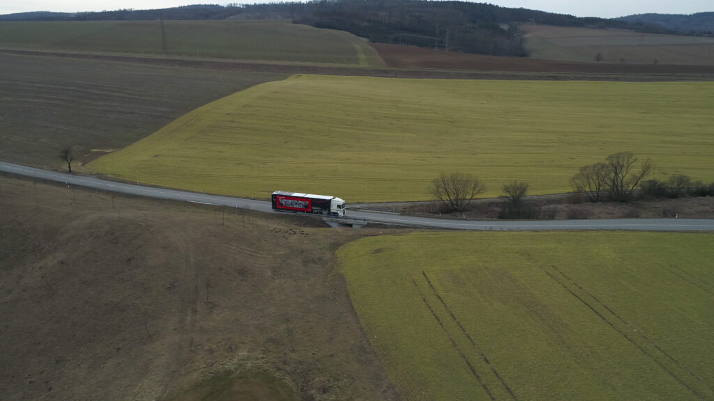 FabLab truck driving in nature photographed from a drone
